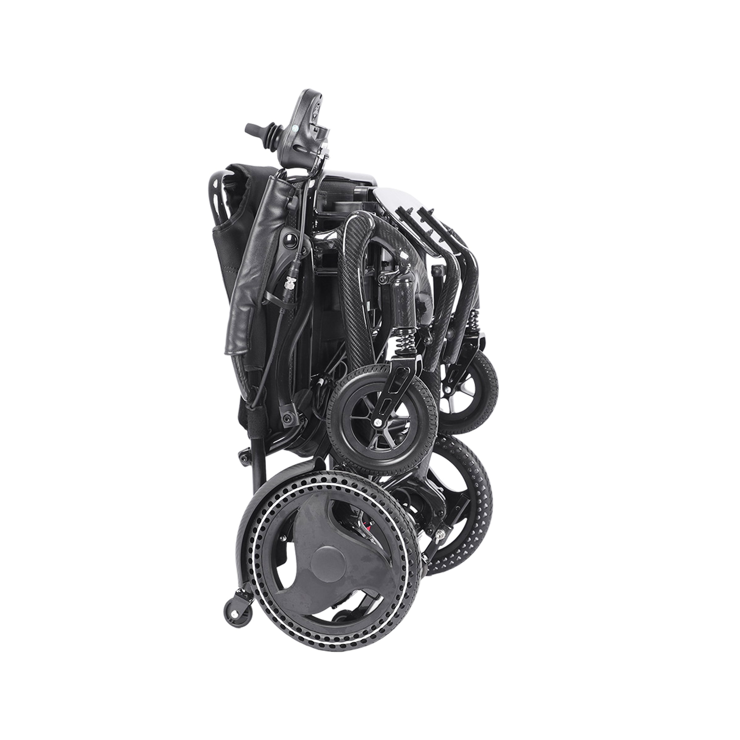 A side view of the Harvey Carbon Power Wheelchair in its completely folded and compact state. The black components are nested together, including the seat and backrest, which are folded up against the main carbon fiber frame. All four wheels (large drive wheels and small casters) are compressed. The joystick controller on its armrest is visible at the top, and the footplate is tucked away, with a small anti-tip wheel on the ground.