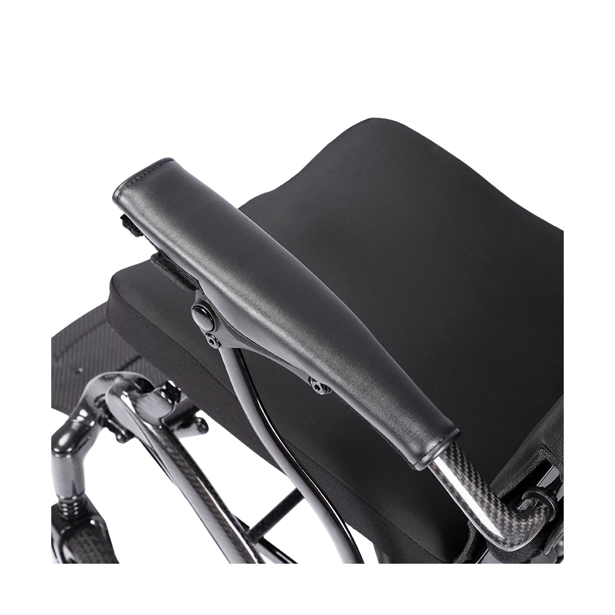 A detailed top-down view of the Harvey Carbon power wheelchair's armrest, highlighting the carbon fiber support tube with its distinct weave pattern and the smooth, ergonomic black padding on top.