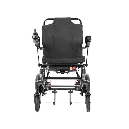 A direct front view of the Harvey Carbon Power Wheelchair. It highlights the wide, padded backrest with ergonomic stitching and the two curved armrests. The joystick controller is mounted on the left armrest. The symmetrical carbon fiber leg rest frame supports a footplate. The central frame-mounted console with the red power switch is clearly seen.