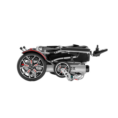 Side profile of the silver frame Muvon Equinox power wheelchair in its fully folded, compact storage configuration