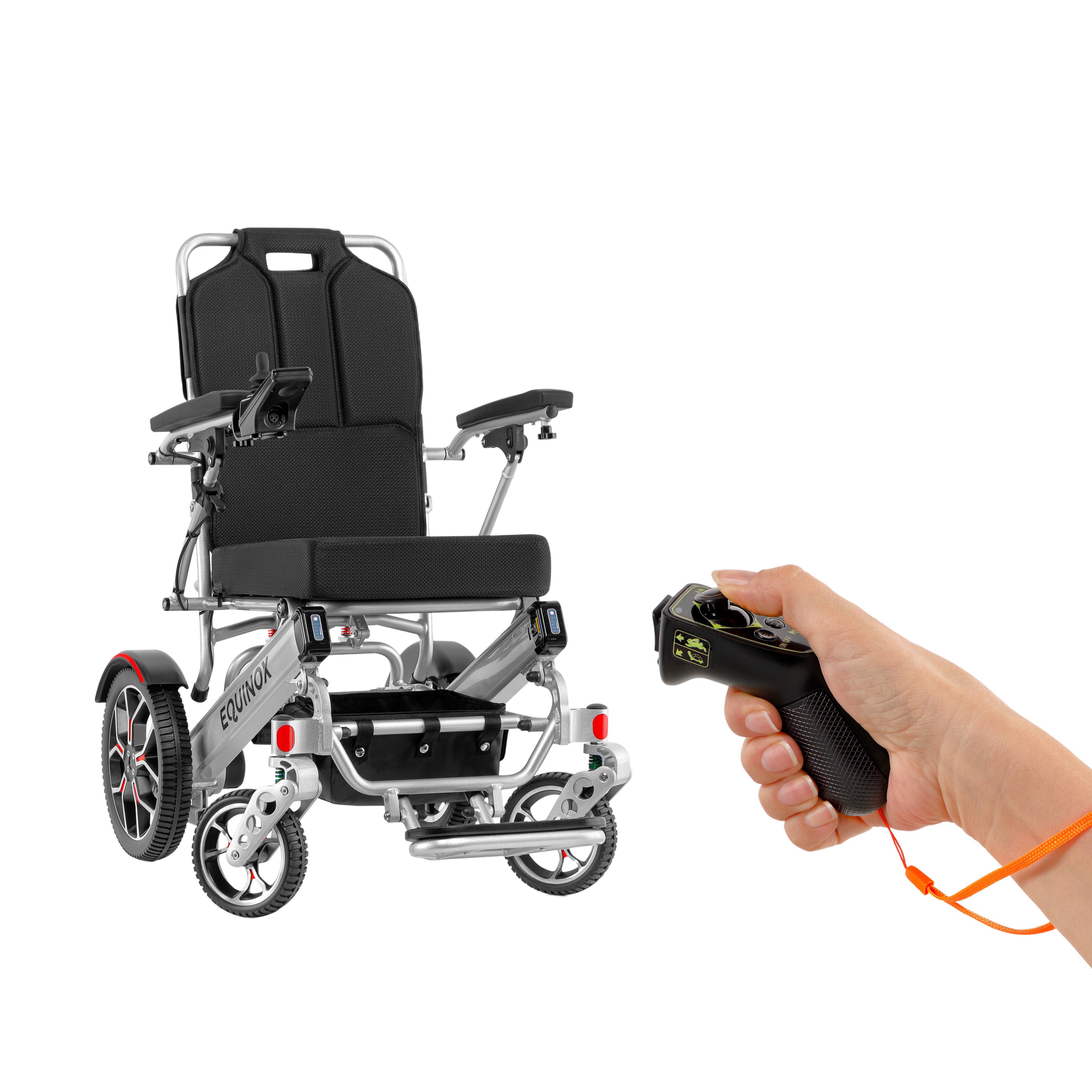 Close-up detail of a human hand interacting with the sophisticated control box of the Muvon Equinox power wheelchair, showing button interface and screen.