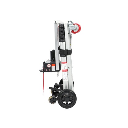 A side view of the Muvon Mobility portable lift, shown in its compact, fully folded position for storage or transport. The lift features a vertical silver aluminum frame with a black motor housing and control box attached to the side. It is equipped with large black rubber wheels at the base for easy movement and a smaller red caster wheel at the top of the folded assembly.