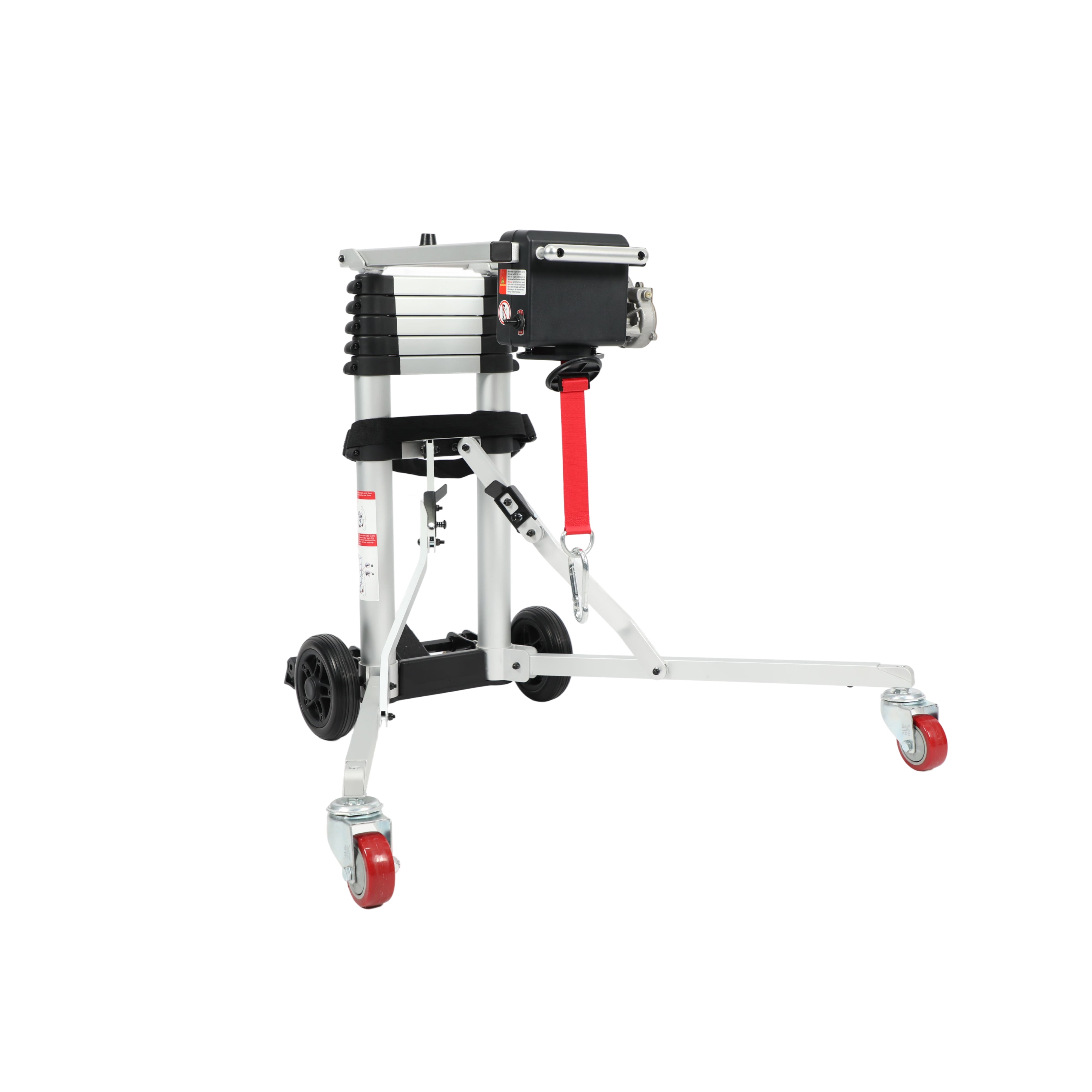 A front-angled view of the Muvon Mobility portable lift in its fully deployed, operational state. The silver aluminum legs are extended outward into a wide, stable tripod base, supported by two red caster wheels at the front and two large black wheels at the rear. The central telescopic mast is shown in its lowered position, and a black motor unit is mounted at the top with a red lifting strap and metal carabiner hanging ready for use.